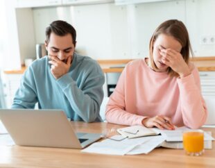 Man and woman stressed over paperwork.