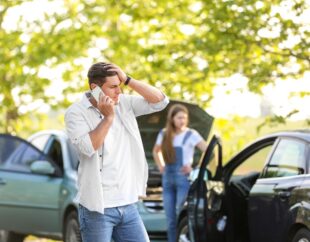 Man at car accident scene